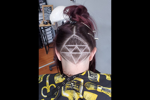 Girl with triangle Hair Tattoo Cut